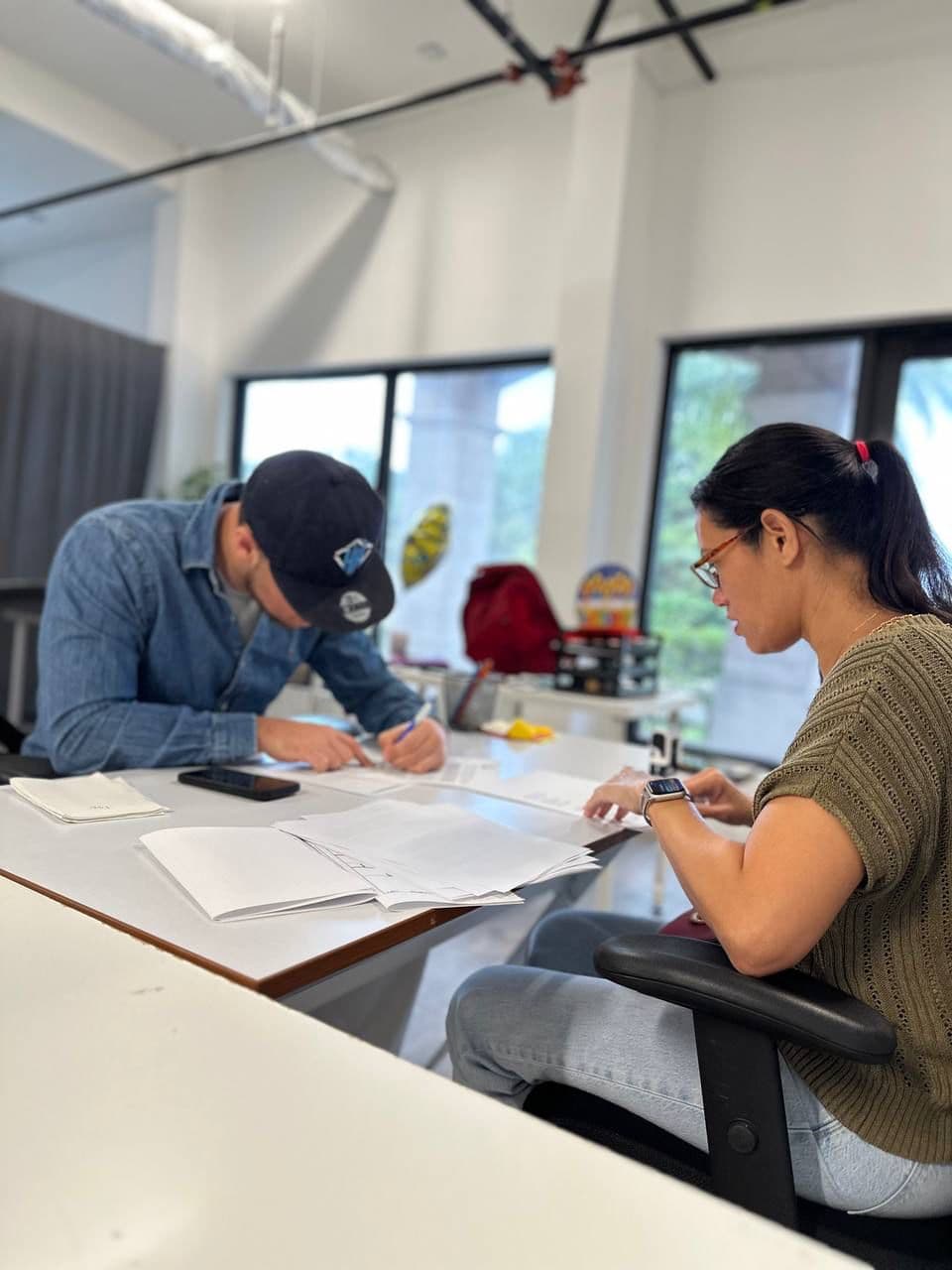 Jonah Stevens reviewing and signing paperwork with a client
