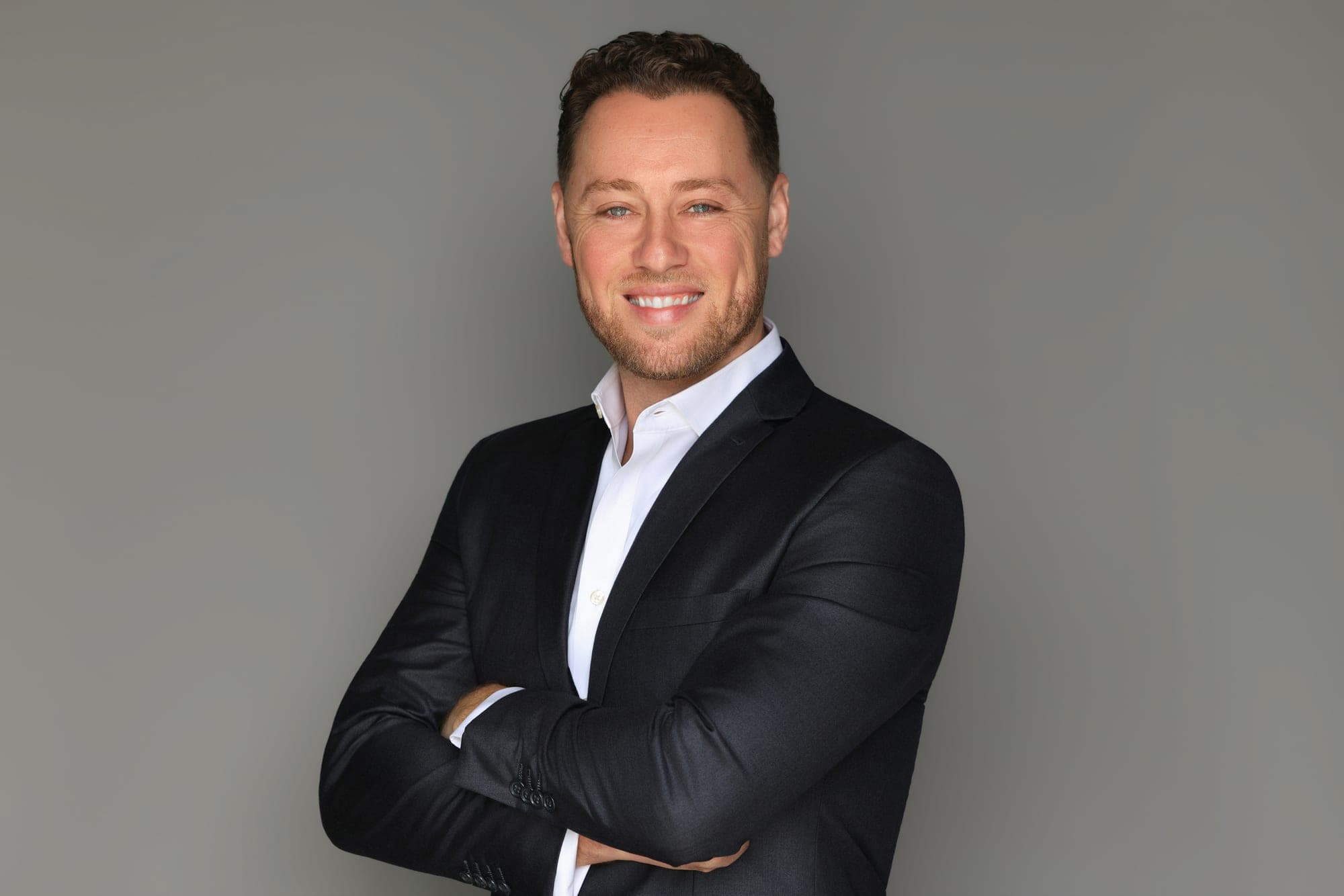 Jonah Stevens, founder of Royal Home Solutions, in a black suit